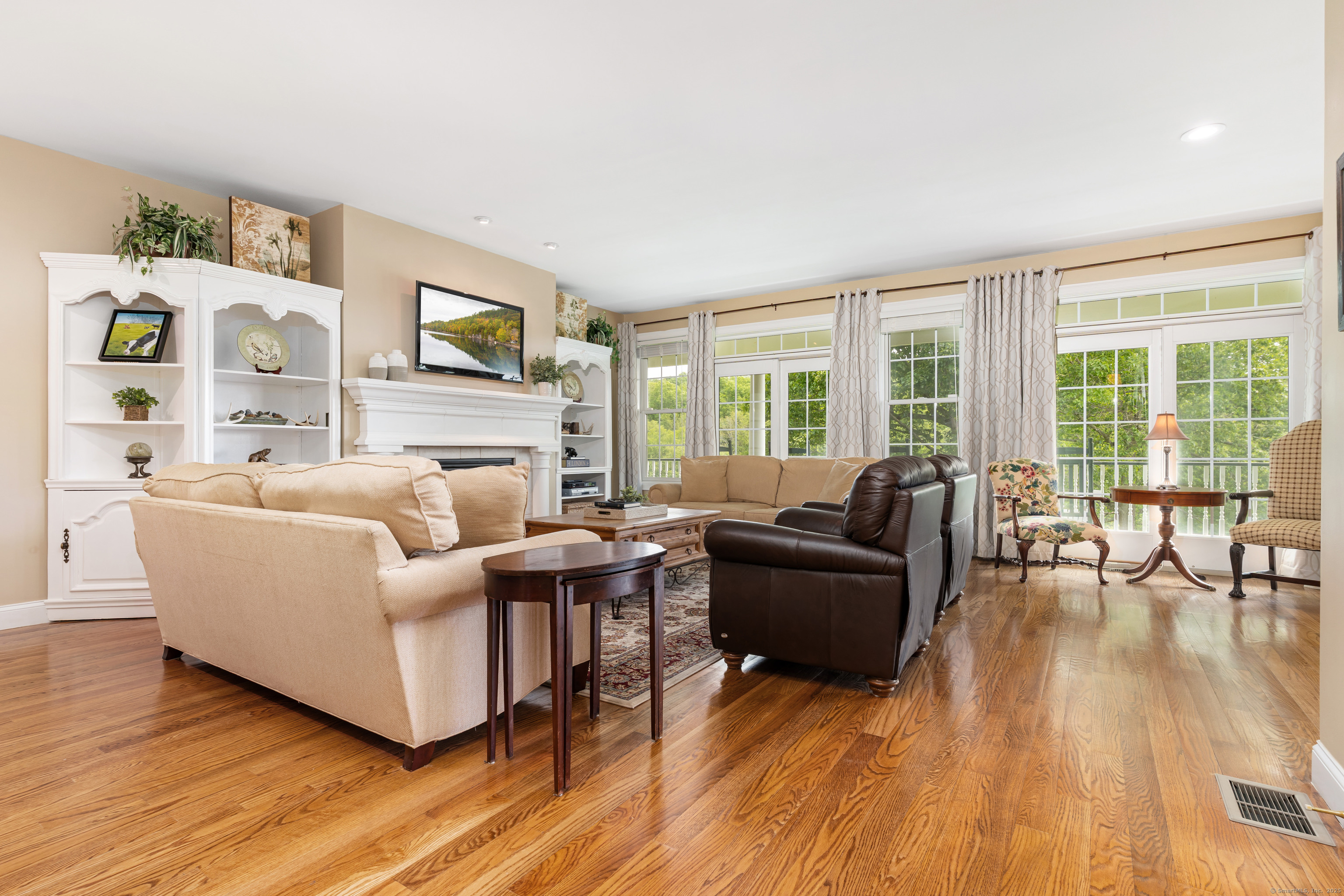 66-86 Bebbington Road Ashford, CT 06278 - Photo 39 of 39 a living room with fireplace furniture and floor to ceiling windows