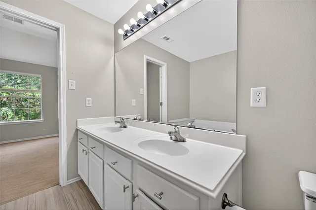 a bathroom with a sink double vanity and a mirror