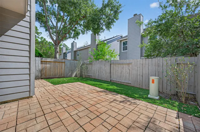 a small yard with wooden fence