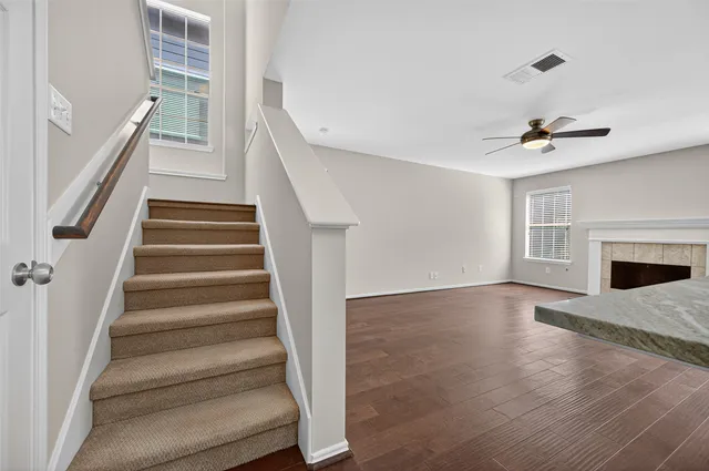 a view of an entryway with wooden floor and a fireplace