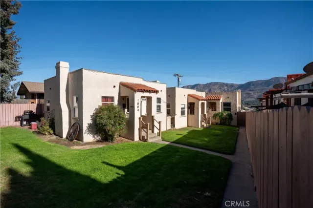 a view of a house with backyard and porch