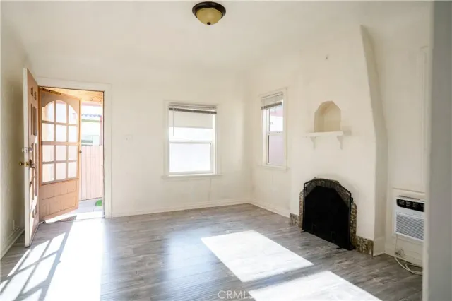 wooden floor in living room with a fireplace