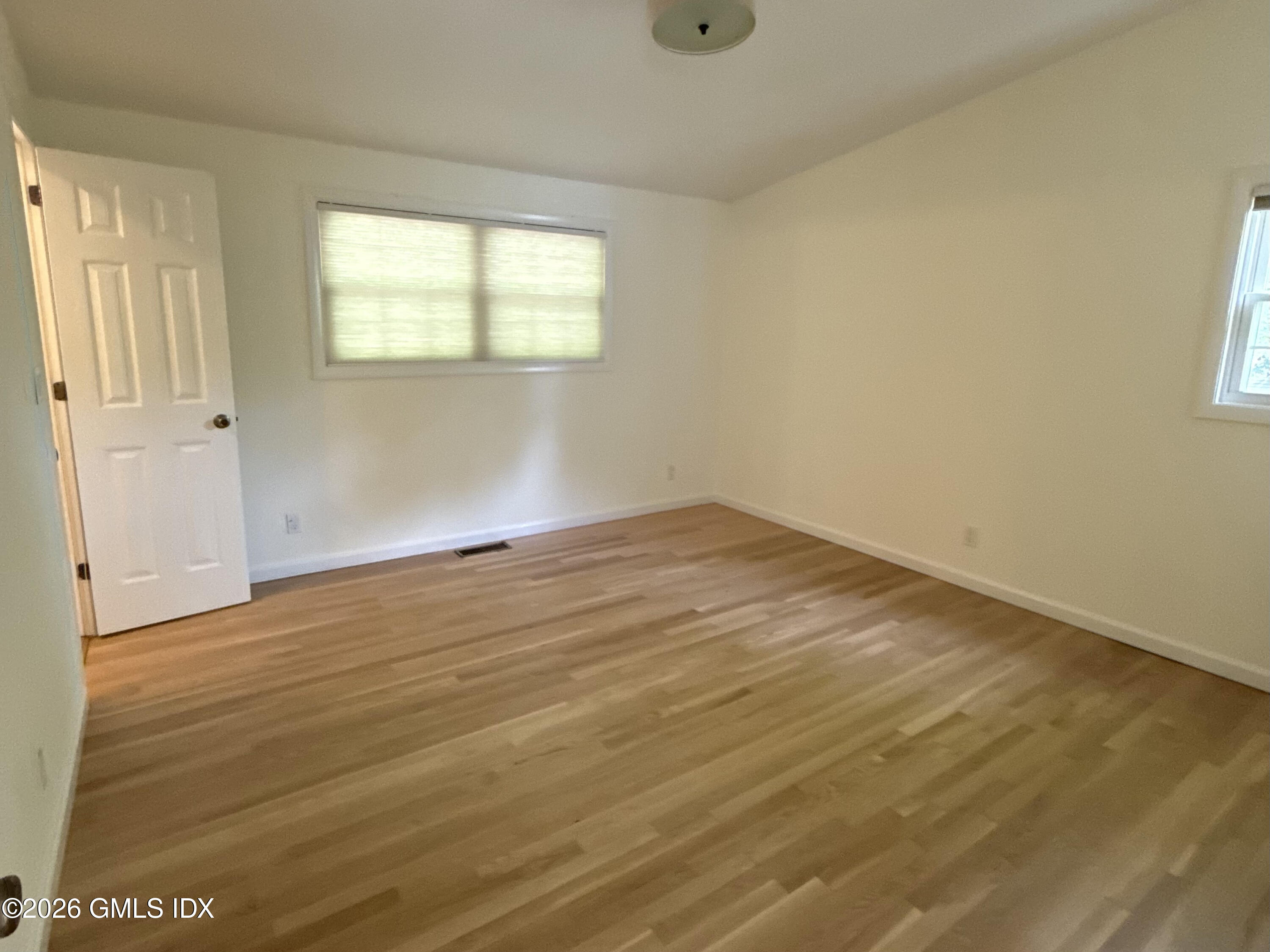 37 Amherst Road Riverside, CT 06878 - Photo 10 of 25 an empty room with wooden floor and windows