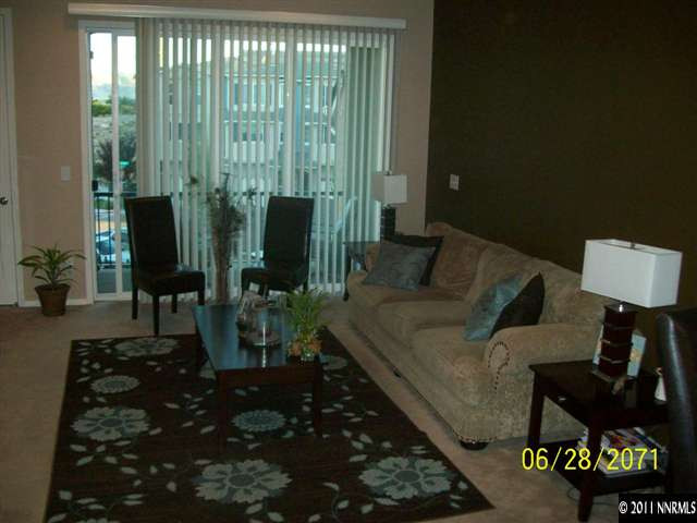 3094 Sterling Ridge Circle Sparks, NV 89431 - Photo 2 of 8 a living room with furniture and a floor to ceiling window