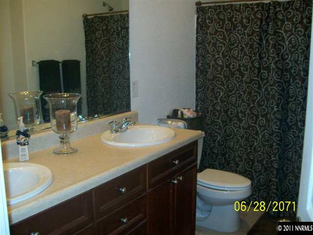 3094 Sterling Ridge Circle Sparks, NV 89431 - Photo 5 of 8 a bathroom with a sink a toilet and a mirror