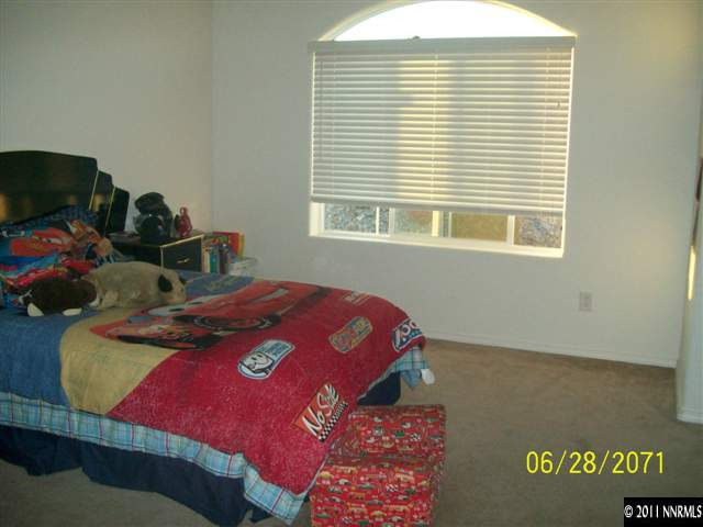 3094 Sterling Ridge Circle Sparks, NV 89431 - Photo 6 of 8 a bedroom with a bed and a window