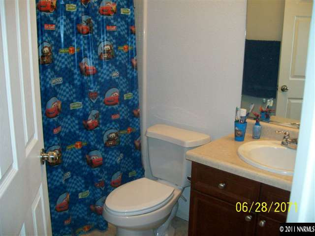 3094 Sterling Ridge Circle Sparks, NV 89431 - Photo 7 of 8 a bathroom with a granite countertop toilet and a sink