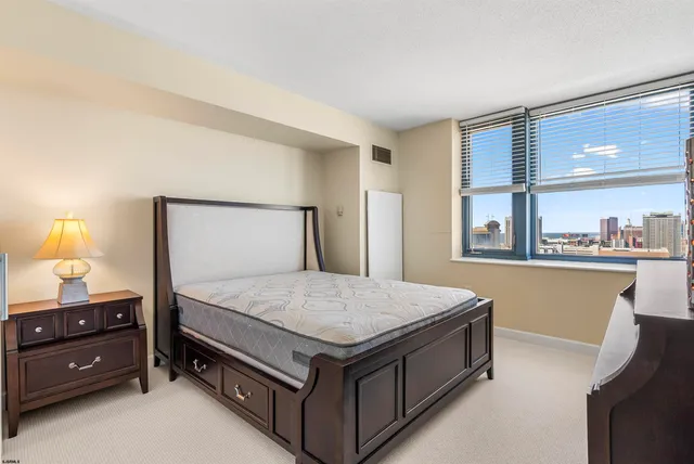 a bedroom with a bed and a night stand