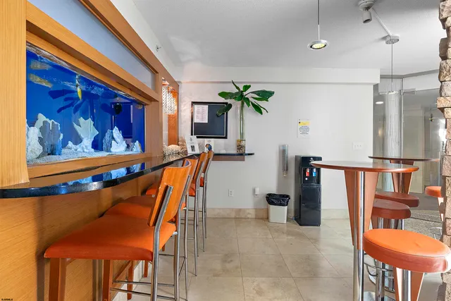 a dining room with furniture and a potted plant