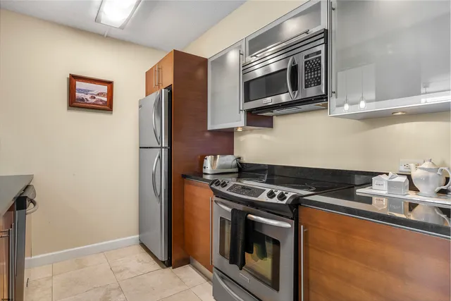 a kitchen with stainless steel appliances granite countertop a stove and a microwave