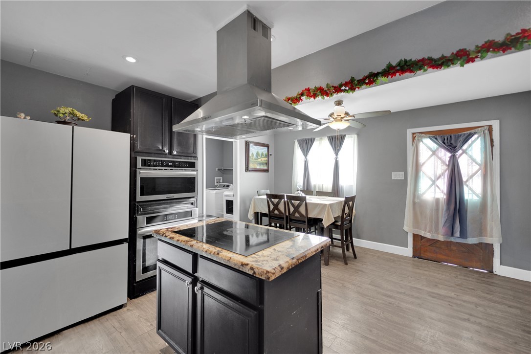 2221 Englestad Street North Las Vegas, NV 89030 - Photo 13 of 32 Culinary adventures await in this kitchen featuring an island cooktop and built-in appliances.