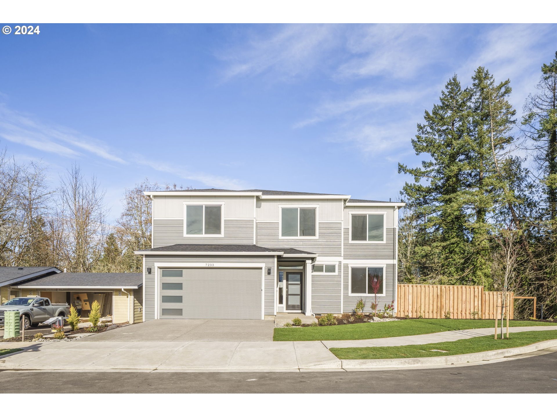 7233 Northeast Ridge Drive Hillsboro, OR 97124 - Photo 1 of 24 a front view of a house with a yard