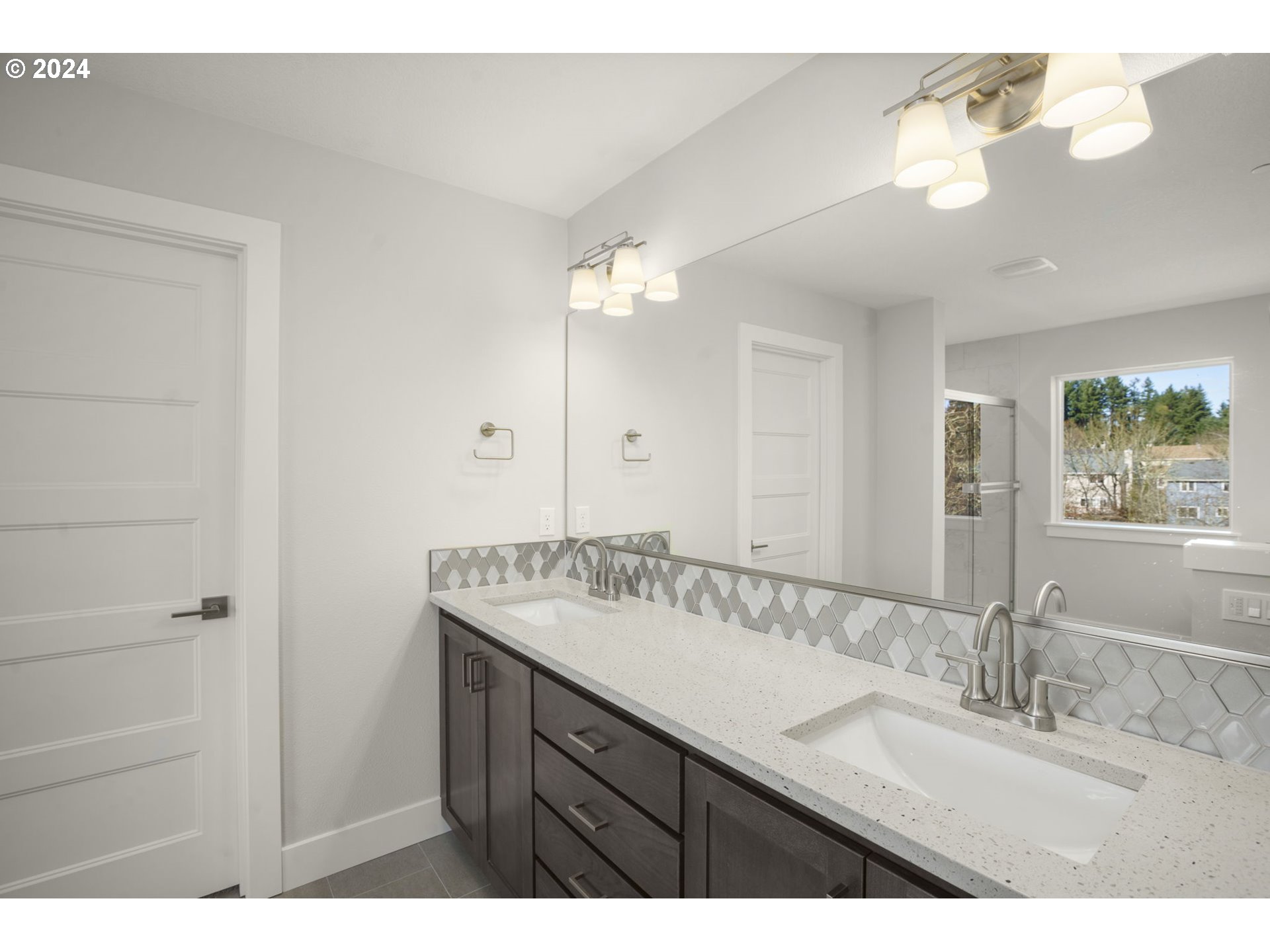 7233 Northeast Ridge Drive Hillsboro, OR 97124 - Photo 12 of 24 a bathroom with a granite countertop sink a large mirror and a