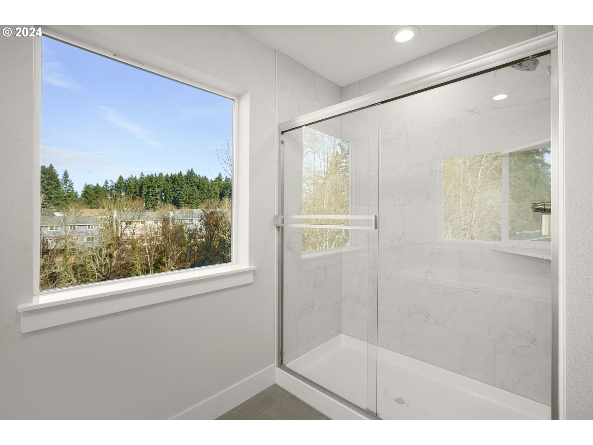 7233 Northeast Ridge Drive Hillsboro, OR 97124 - Photo 14 of 24 a bathroom with a glass shower door