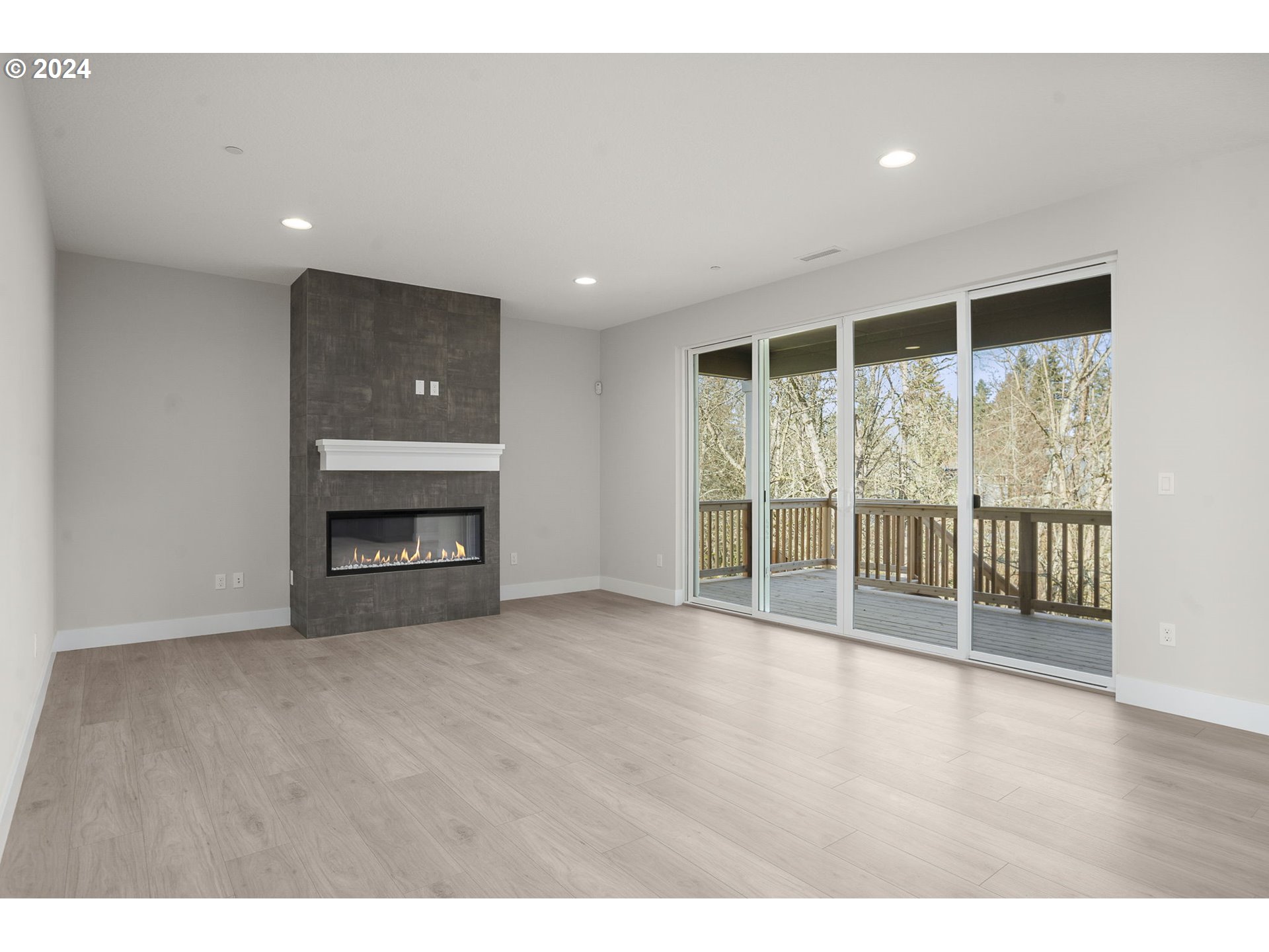 7233 Northeast Ridge Drive Hillsboro, OR 97124 - Photo 5 of 24 a view of an empty room with wooden floor and a window