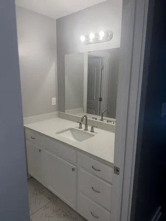 a bathroom with a double vanity sink and a mirror