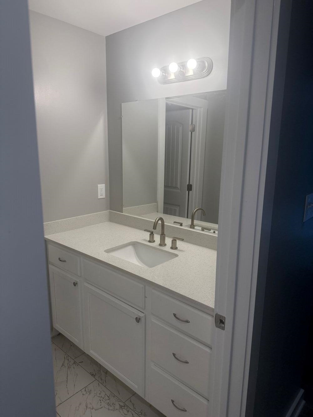 382 Carbon Road Memphis, TN 38109 - Photo 7 of 10 a bathroom with a double vanity sink and a mirror