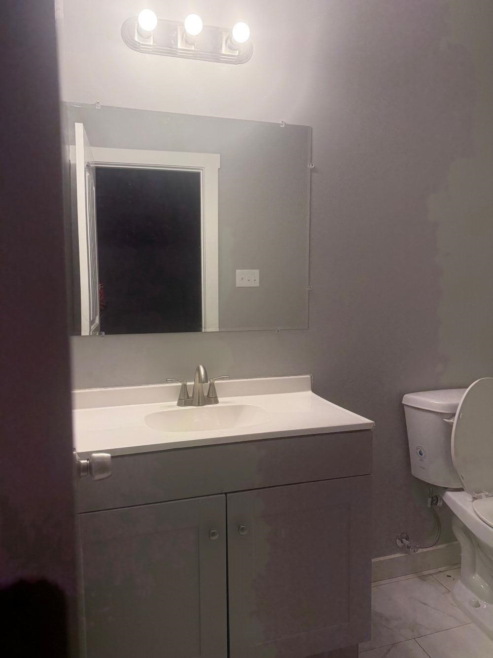 382 Carbon Road Memphis, TN 38109 - Photo 9 of 10 a bathroom with a toilet sink and mirror