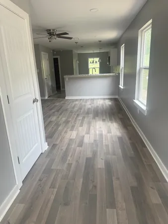 wooden floor in an empty room with a window