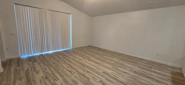 a view of a room with wooden floor