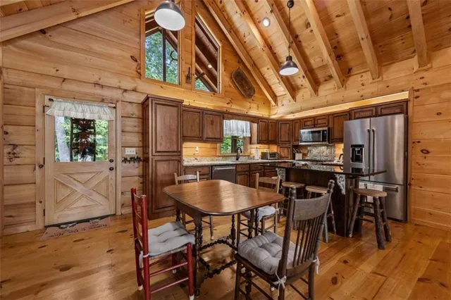 a dining room with furniture and wooden floor
