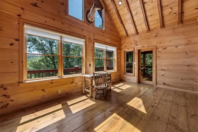 a living room with furniture and large windows