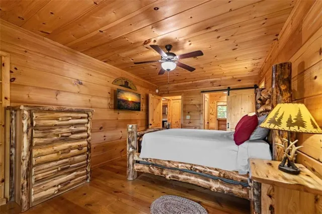 a bedroom with a bed and ceiling fan