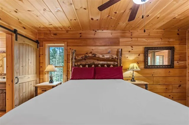 a bedroom with a bed and a chandelier
