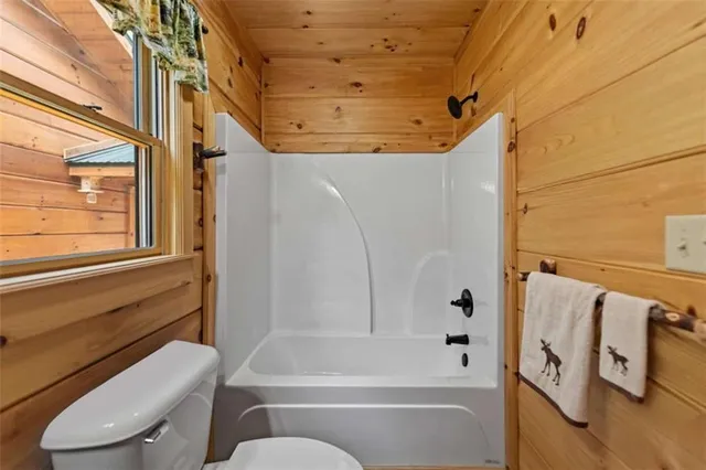 a view of a balcony with chairs and wooden floor