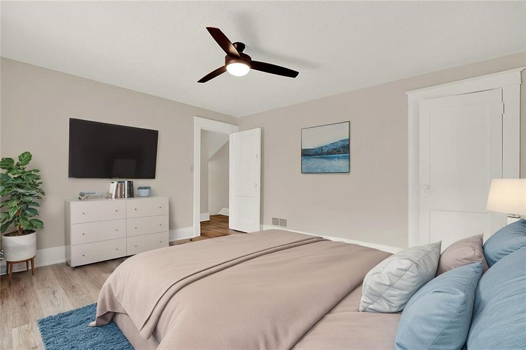 62 1st Street Irwin, PA 15642 - Photo 13 of 27 a bedroom with a bed and a flat screen tv