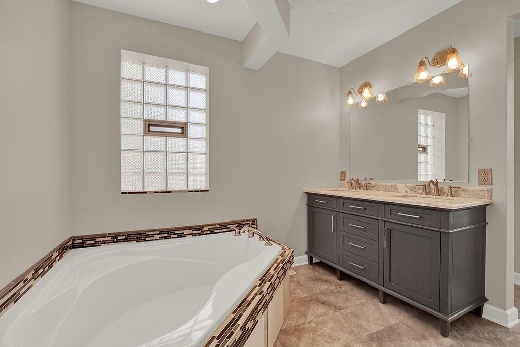 62 1st Street Irwin, PA 15642 - Photo 15 of 27 a bathroom with a tub sink and mirror