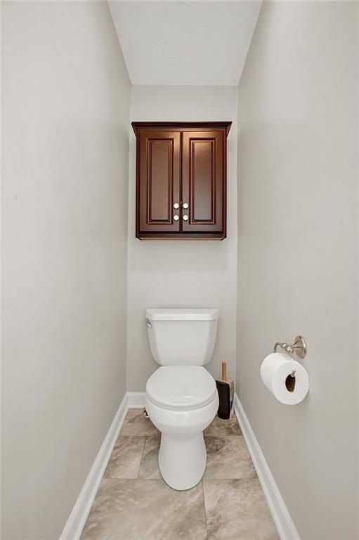 62 1st Street Irwin, PA 15642 - Photo 17 of 27 a bathroom with a toilet sink and mirror