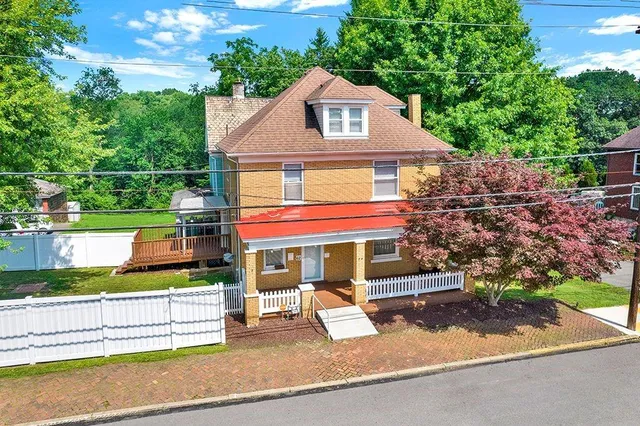 a front view of a house with a yard