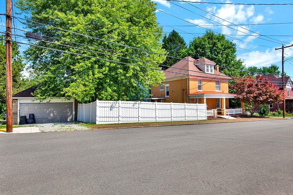 62 1st Street Irwin, PA 15642 - Photo 23 of 27 a front view of a house with a yard and garage