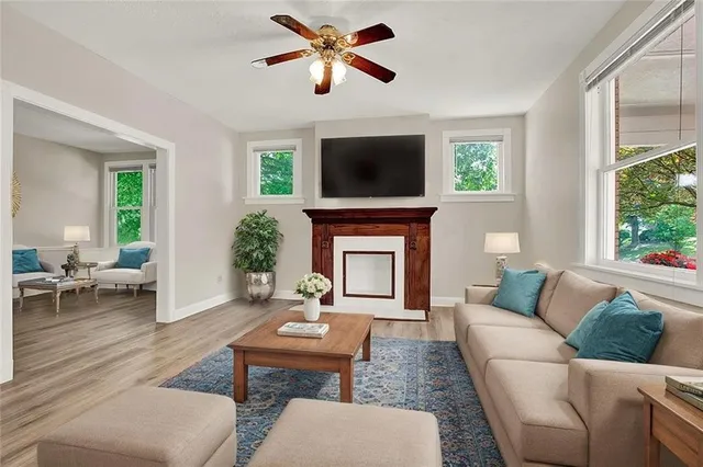 a living room with furniture a fireplace and a flat screen tv