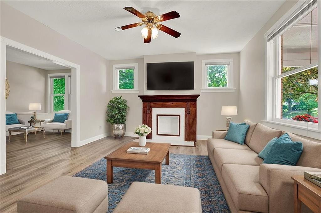 62 1st Street Irwin, PA 15642 - Photo 4 of 27 a living room with furniture a fireplace and a flat screen tv