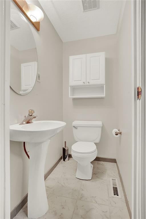 62 1st Street Irwin, PA 15642 - Photo 6 of 27 a bathroom with a sink toilet and mirror