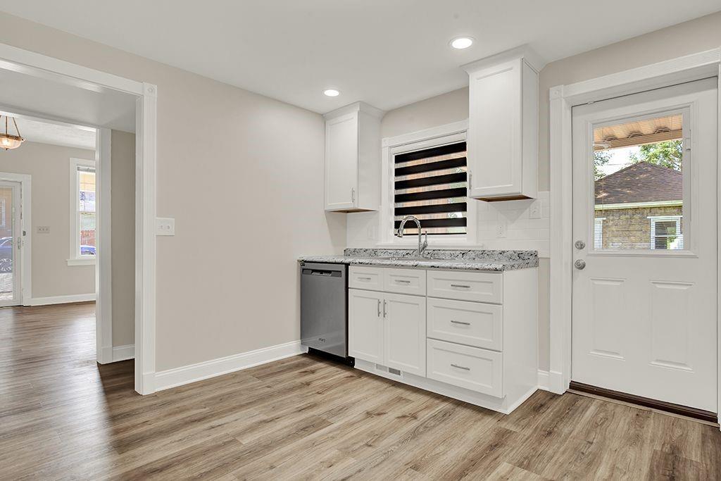 62 1st Street Irwin, PA 15642 - Photo 10 of 27 wooden floor with white cabinets and wooden floor
