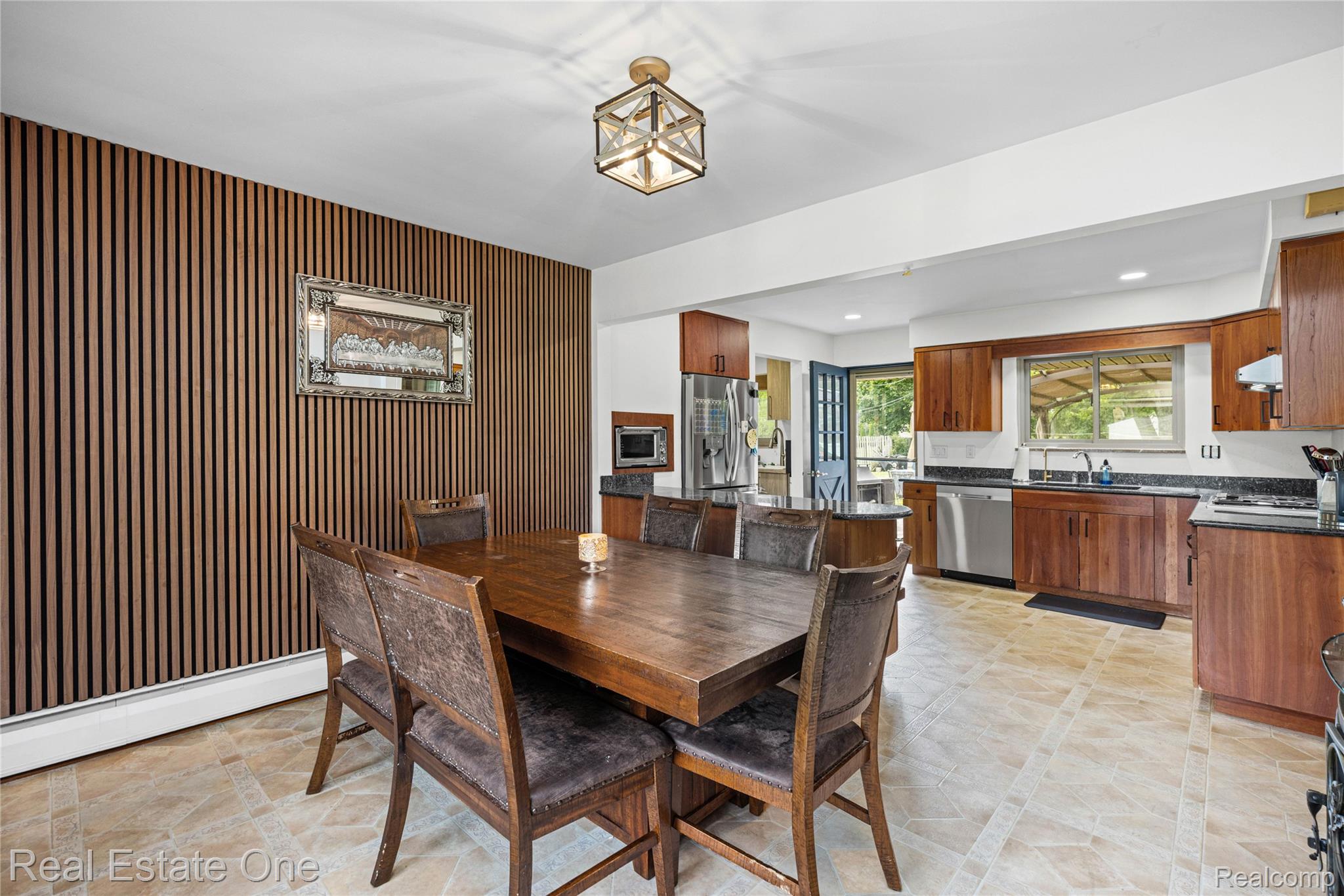 2810 Walbridge Drive Rochester, MI 48307 - Photo 21 of 58 Open-concept dining area featuring a distinctive slat-panel accent wall and tile flooring