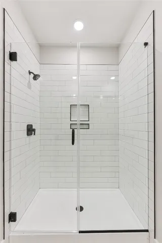 a bathroom with a granite countertop sink a mirror and shower