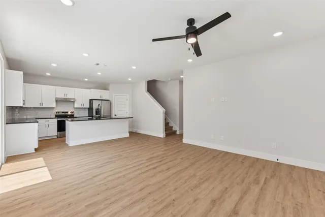 a view of kitchen with refrigerator sink and cabinets
