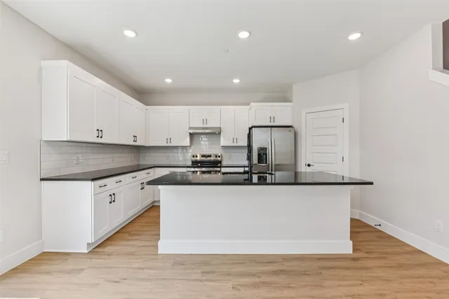 a view of kitchen with cabinets and wooden floor