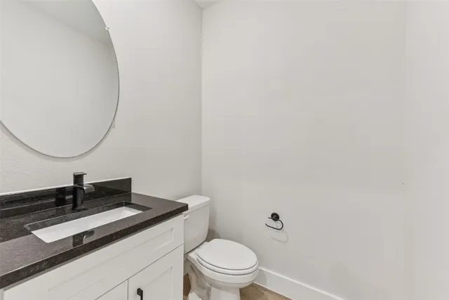 a kitchen that has a sink a table and chairs in it