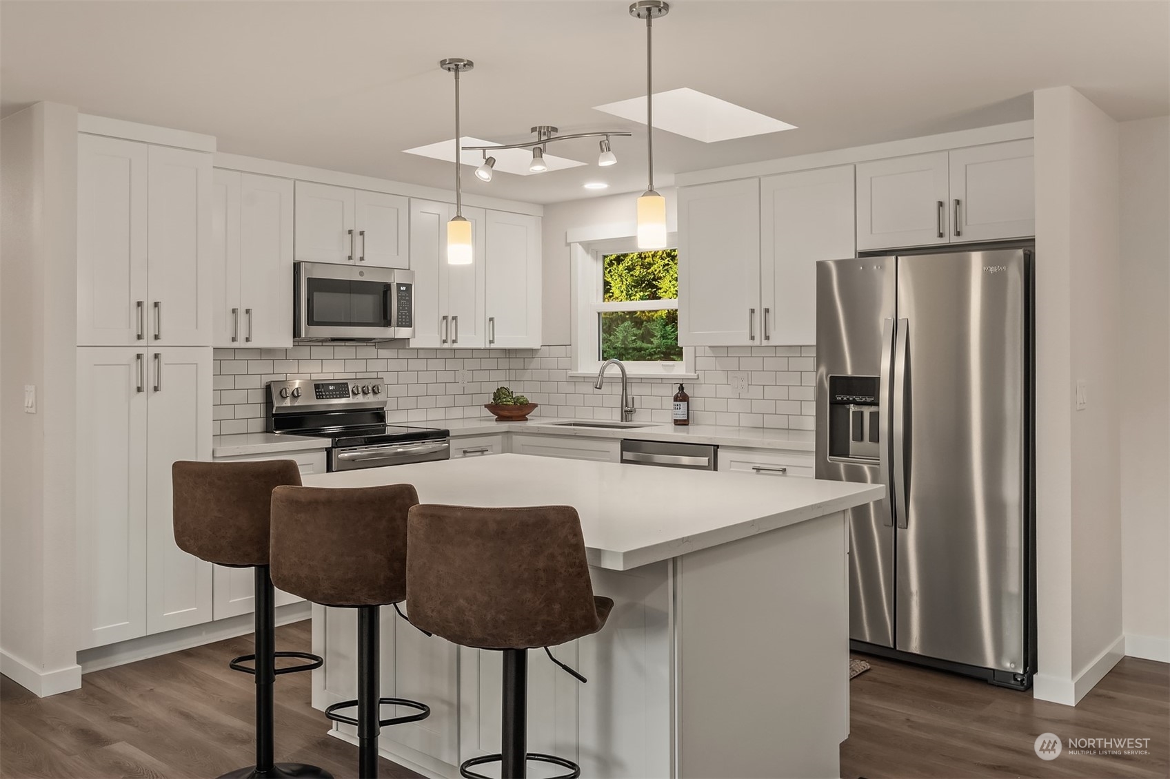 1005 Ave A Snohomish, WA 98290 - Photo 4 of 27 a kitchen with kitchen island a refrigerator stove and microwave