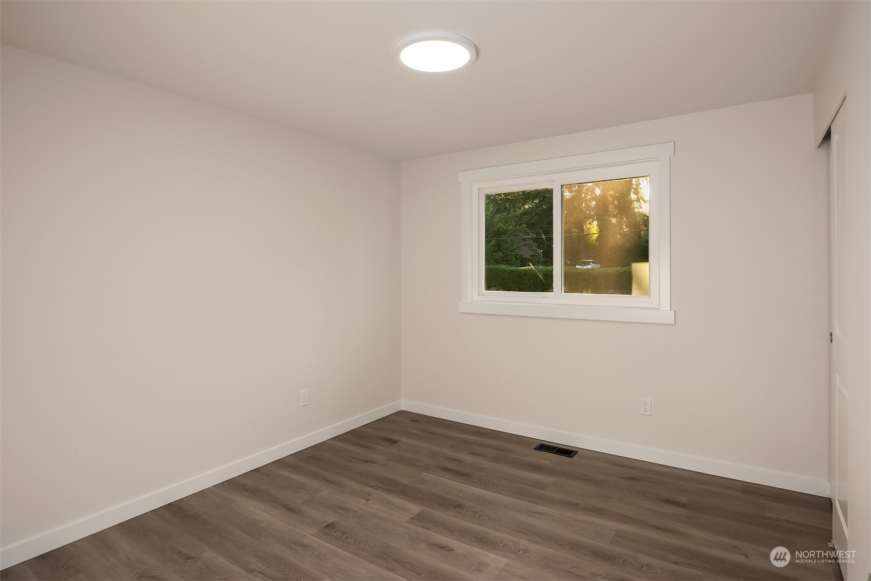 1005 Ave A Snohomish, WA 98290 - Photo 10 of 27 a view of an empty room with wooden floor and a window