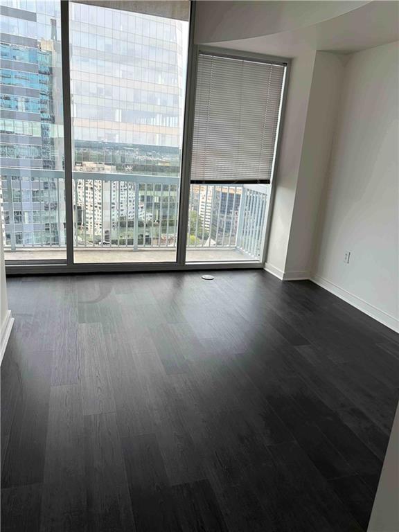 3324 Peachtree Road, Unit 2213 Atlanta, GA 30326 - Photo 6 of 28 a view of an empty room with wooden floor and a window