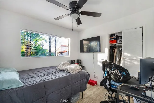 a bedroom with a bed and a flat screen tv