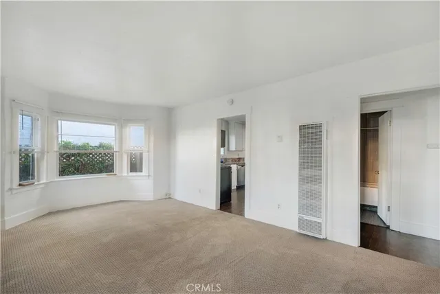 a kitchen with granite countertop a sink stove and microwave