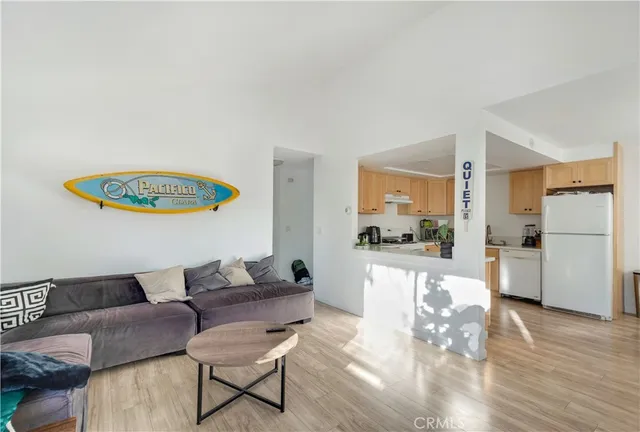 a living room with furniture and a kitchen view