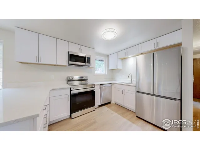 a kitchen with appliances cabinets and a sink